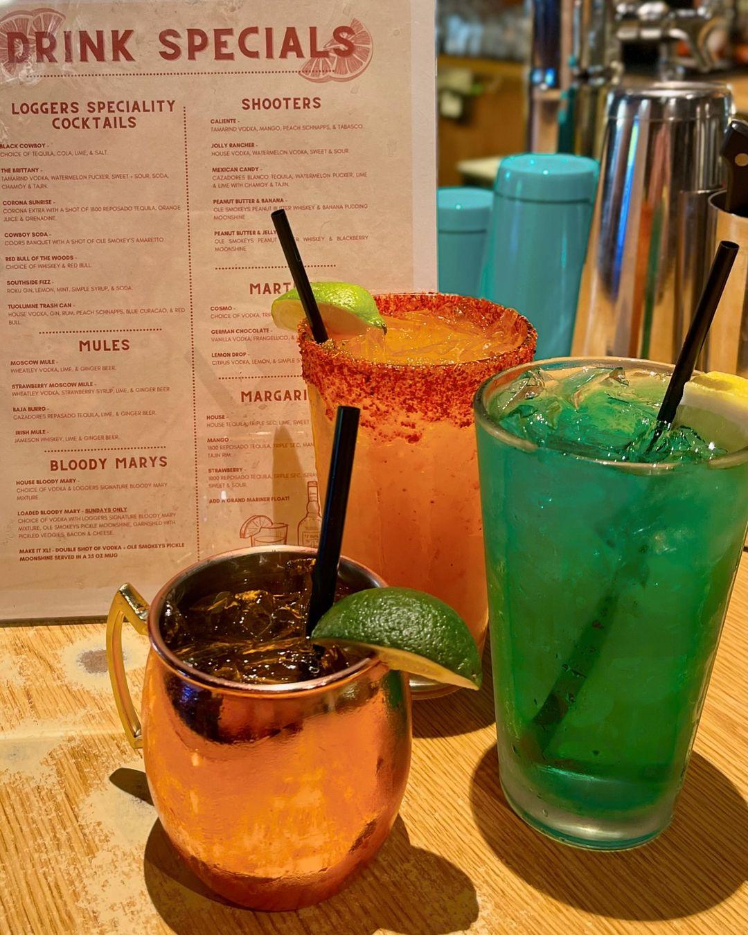 Three frosty specialty drinks sit on the bar at Loggers.